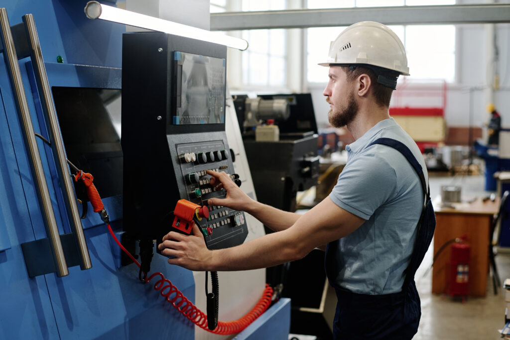 man operating cnc machine